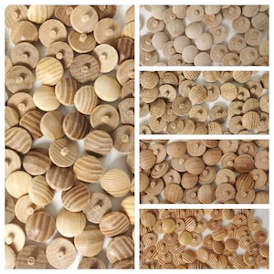 May include: A close-up view of a large quantity of wooden buttons in various shades of brown. The buttons have a smooth, rounded surface and a small hole in the centre. Some buttons have a grooved pattern on the surface.