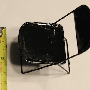 May include: A black metal folding chair with a black painted seat. The chair is about 10 inches tall.