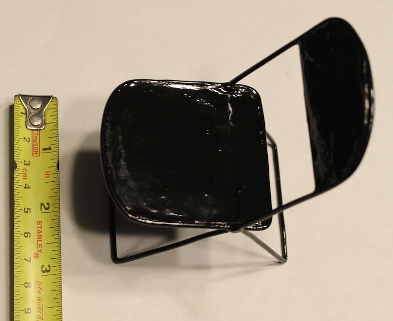 May include: A black metal folding chair with a black painted seat. The chair is about 10 inches tall.