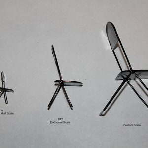 May include: Three black metal chairs in different sizes. The chairs are made of thin metal and have a simple design. The smallest chair is labeled "1/24 Dollhouse Half Scale", the middle chair is labeled "1/12 Dollhouse Scale", and the largest chair is labeled "Custom Scale".