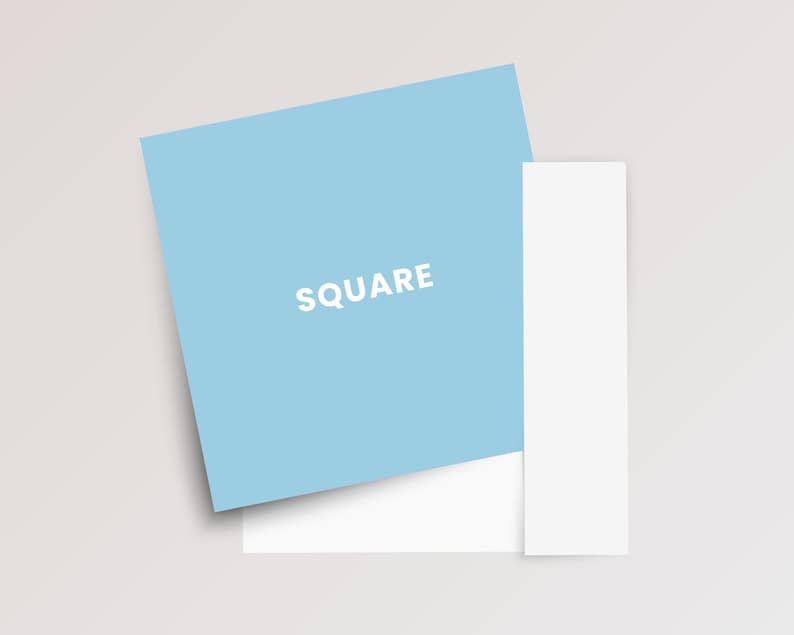 May include: A light blue square card with the word SQUARE printed in white capital letters, positioned partially overlapping a plain white rectangular card and a separate vertical white strip on a neutral light gray background.