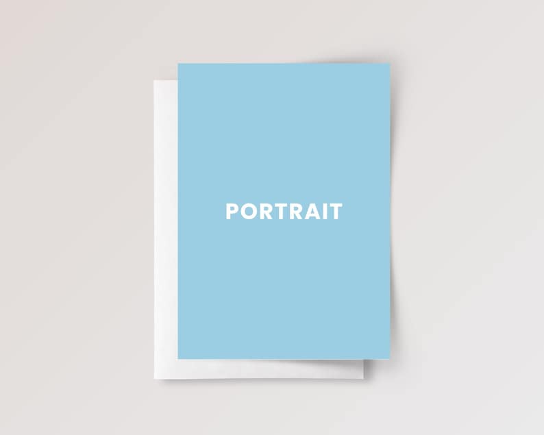 May include: A light blue rectangular greeting card with the word PORTRAIT printed in white capital letters in the center. The card is positioned slightly offset, revealing a plain white card base underneath the light blue top layer.