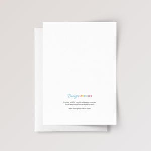 May include: A white greeting card with a blank front and back side featuring the text DesignSprinkles in multicolored letters, followed by the text Printed on FSC certified paper sourced from responsibly managed forests and www.designsprinkles.com.