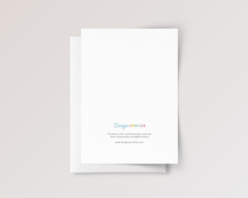 May include: A white greeting card with a blank front and back side featuring the text DesignSprinkles in multicolored letters, followed by the text Printed on FSC certified paper sourced from responsibly managed forests and www.designsprinkles.com.
