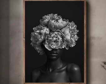 May include: Black and white photograph of a person with a bouquet of white flowers covering their face. The background is black.