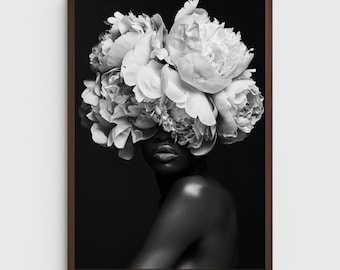 May include: Black and white photograph of a person with white peonies covering their face and shoulders. The person is looking to the side and has their shoulders and neck exposed.