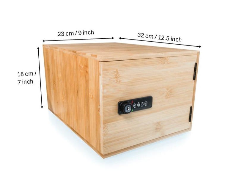 May include: A rectangular wooden box with a combination lock. The box is made of light-colored wood and measures 9 inches wide, 12.5 inches long, and 7 inches high. The lock is black and has a series of number dials.