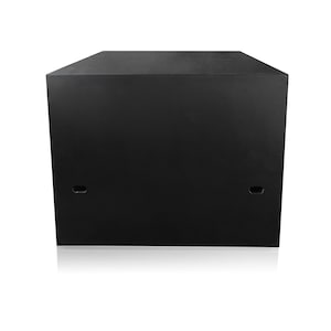 May include: A large, black, rectangular speaker cabinet with a flat top and two small, oval-shaped openings on the front. The cabinet is made of a solid, dark material and sits on a white surface.