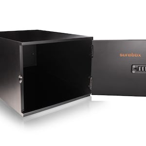 May include: A black, rectangular safe with the door open, revealing an empty interior. The open door displays the word "surebox" in orange, along with a combination lock and a silver handle. The safe is designed to secure valuables.