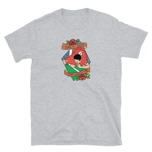 May include: A gray t-shirt with a graphic of a football player in a red jersey with the text "ONLY GOD CAN JUDGE ME" in a banner above the player.