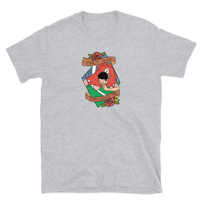May include: A gray t-shirt with a graphic of a football player in a red jersey with the text "ONLY GOD CAN JUDGE ME" in a banner above the player.