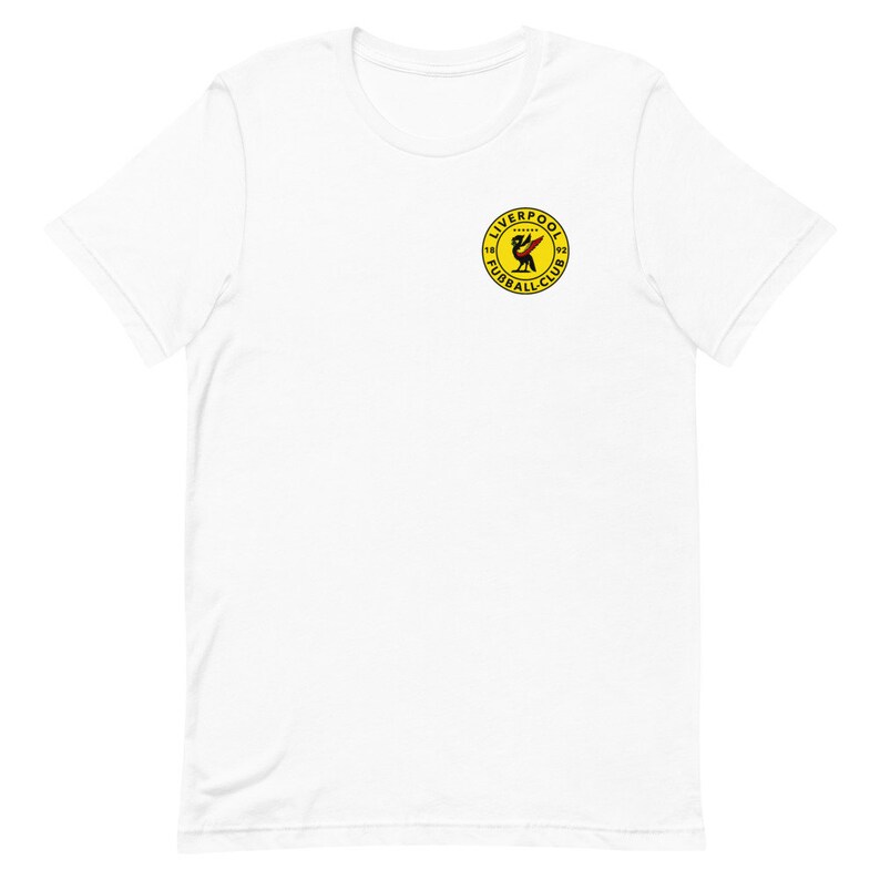 May include: White t-shirt with a yellow circle logo featuring a red bird and the text "Liverpool Football Club 1892"