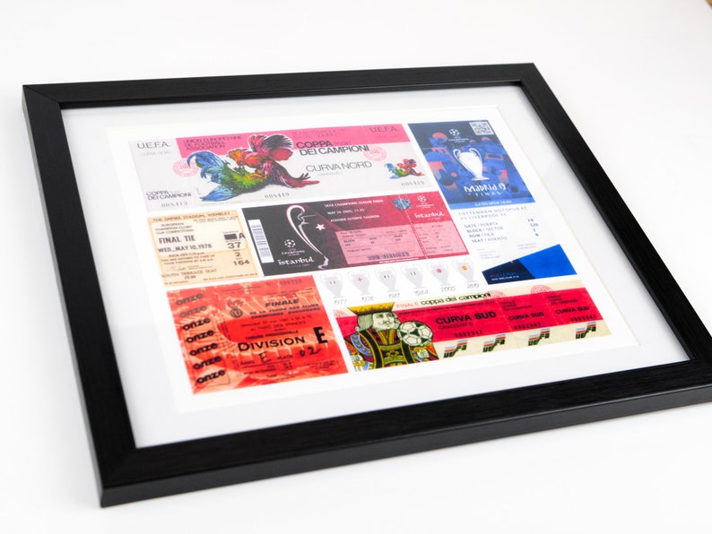 May include: A framed collage of vintage European football tickets. The tickets are from different teams and matches, including the 1979 European Cup Final. The tickets are in various colors, including red, blue, and green. The tickets are displayed in a black frame.