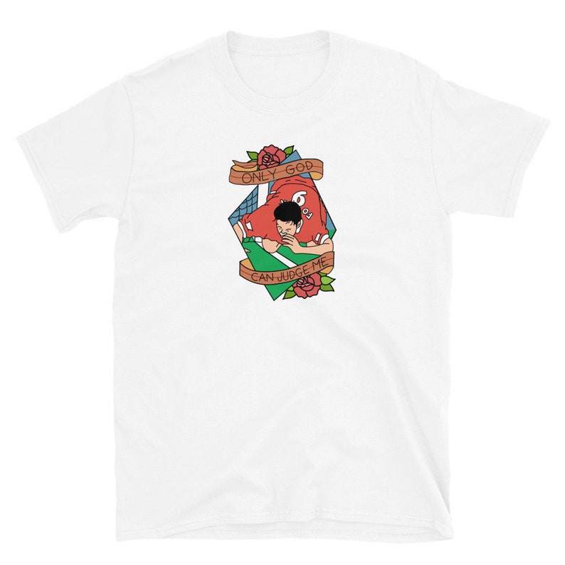 May include: White t-shirt with a graphic of a football player in a red jersey with the text "Only God Can Judge Me" in a diamond shape with roses.