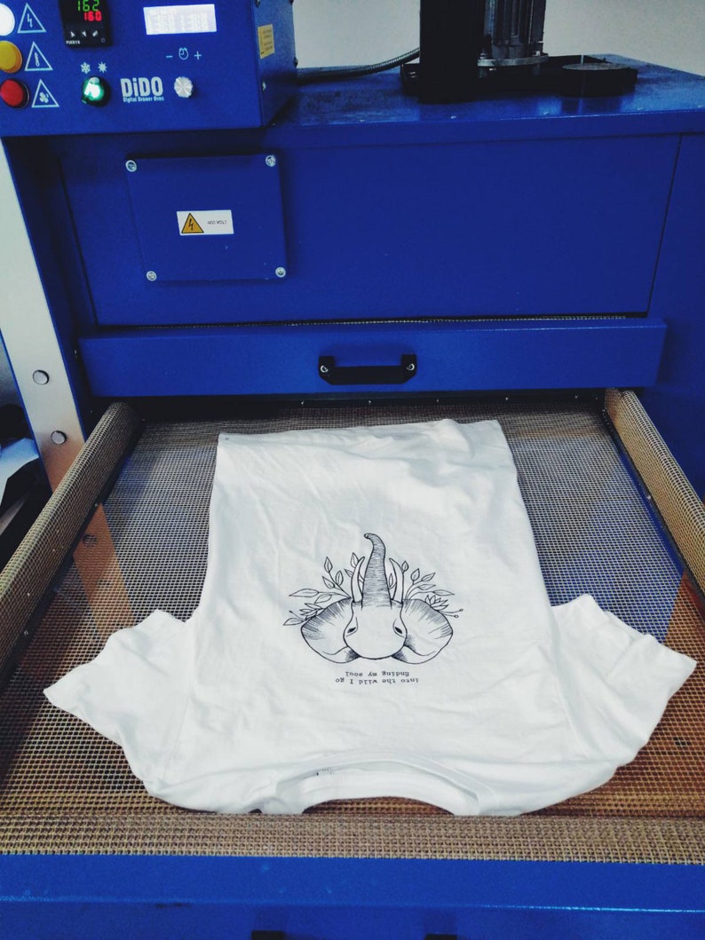 May include: A white t-shirt with a black and white illustration of two elephants with the text "Trees are saying oh I pity the ones".