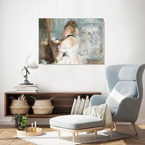 May include: A framed print of a woman in a white dress, viewed from the back, looking into a mirror. The artwork has a soft, impressionistic style with a muted color palette of blues, whites, and browns. The woman is wearing a black choker.