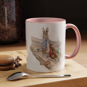 A personalised Beatrix Potter Mug with your name is available in navy and pink. Please provide your name, and we will print it for you.