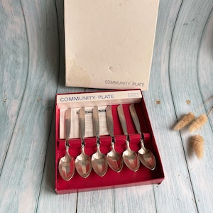 May include: A set of six silver Community Plate teaspoons in a red box with a white label that reads "Community Plate".