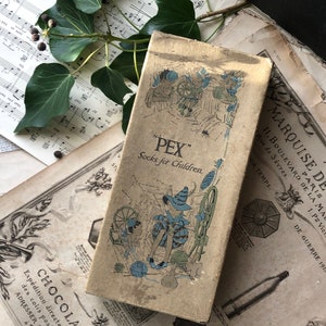 May include: A vintage box of "PEX" socks for children. The box is brown with a faded image of two children knitting. The text "PEX" and "Socks for Children" is printed on the box.