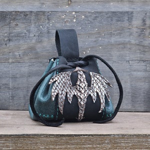 Small leather belt pouch with a silver scaled dragon hand sewn on the front. The main body is the color of your choice (green or red). The bag has a drawstring closure.