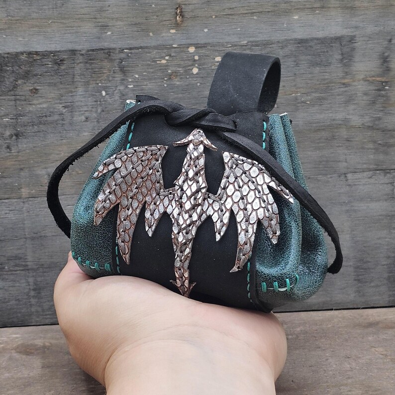 This small pouch is designed for carrying smaller items and easily fits in the palm of my hand for size reference.