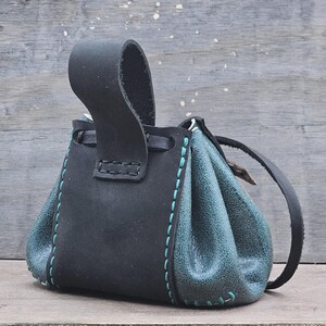 The bag has a belt loop attachment for your belt to slip through and hold. This pouch is small and great for Renaissance Fairs.