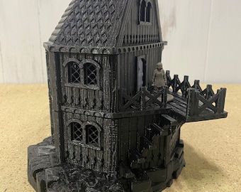 May include: A black, 3D-printed model of a medieval-style tower with a bridge and a small figure on the balcony. The tower has detailed wooden textures, arched windows, and a decorative roof. The base is made to look like stone.