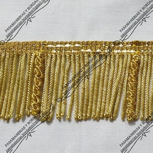 May include: Gold fringe trim with a woven pattern. The fringe is approximately 2.5 cm long.