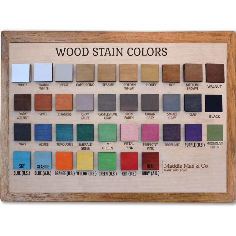 May include: Wooden color chart with a variety of wood stain colors, including white, beige, gray, and various shades of brown, blue, green, and pink. The chart is framed and labeled "Wood Stain Colors."