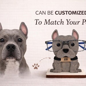 May include: A gray dog sculpture wearing glasses and a name tag that says "JEDI". The text above the sculpture says "CAN BE CUSTOMIZED To Match Your Pet". A realistic dog portrait is on the left.
