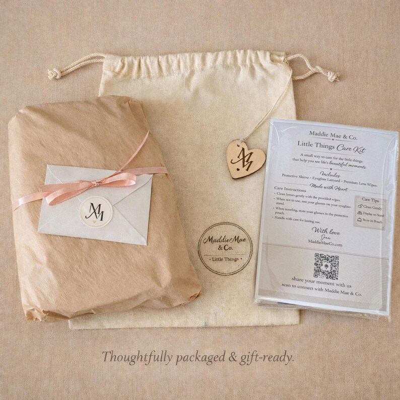 May include: A gift-ready package featuring a wrapped parcel with a pink ribbon, a drawstring bag, and a care kit. The package includes a wooden heart tag with initials and a care kit with instructions. The text "Thoughtfully packaged & gift-ready" is at the bottom.
