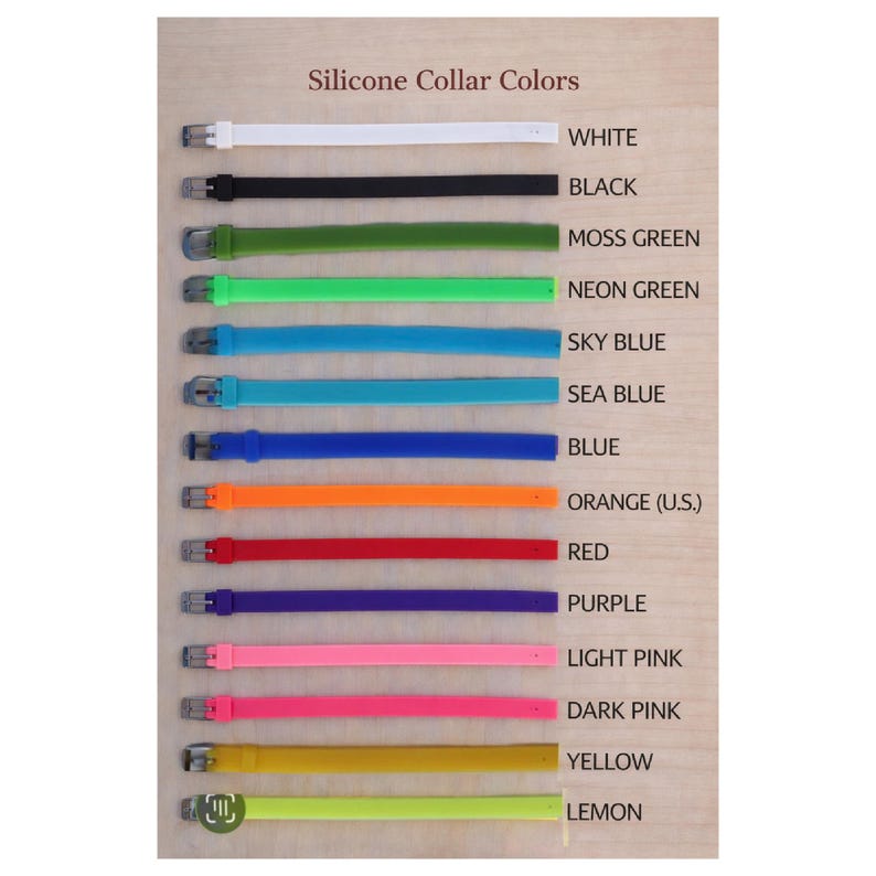 May include: A display of silicone collars in various colors, including white, black, moss green, neon green, sky blue, sea blue, blue, orange, red, purple, light pink, dark pink, yellow, and lemon. Each collar has a silver buckle.