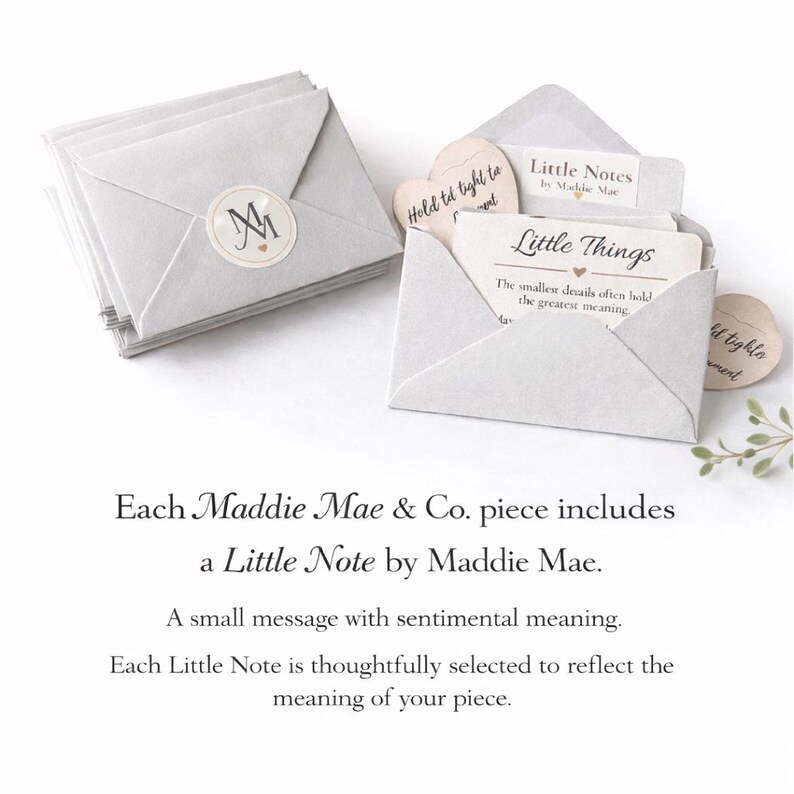 May include: A stack of light gray paper envelopes with a circular sticker featuring the initials "M" and "M". One envelope is open, revealing a card that reads "Little Things" and "Little Notes by Maddie Mae".
