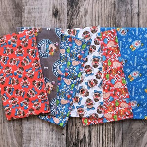 May include: Six colorful fabric headbands with a Mr. Potato Head theme. The headbands feature different patterns and colors, including red, blue, white, and gray. One headband has the text "Mr. Potato Head's Family Fries!" printed on it.