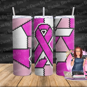 May include: Three pink and white patterned stainless steel tumblers with a pink ribbon design on the center tumbler. The tumblers are on a wooden surface with a laptop, a printer, and a woman holding a camera and a paintbrush.