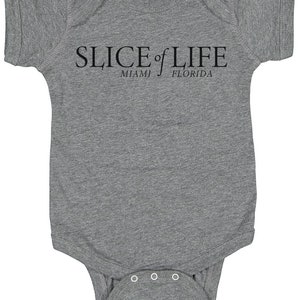 May include: A gray baby onesie with black text that reads "SLICE of LIFE" with "MIAMI" and "FLORIDA" underneath.