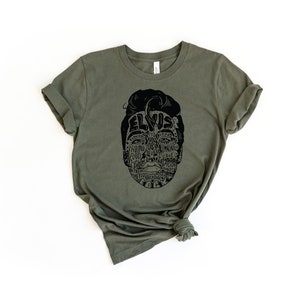 May include: A green t-shirt with a black graphic of Elvis Presley's face made up of words related to his music and career.