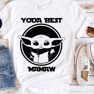 May include: White t-shirt with a black and white graphic of a character from Star Wars, "Yoda Best Mamaw".
