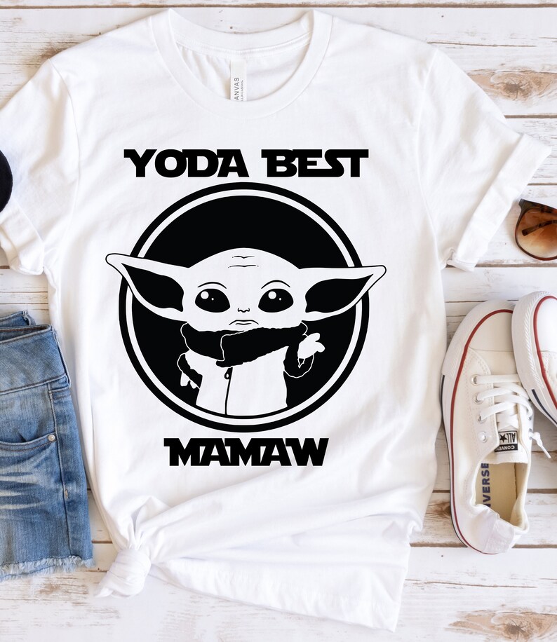 May include: White t-shirt with a black and white graphic of a character from Star Wars, "Yoda Best Mamaw".