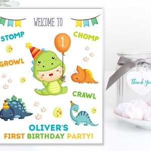May include: A printable sign for a dinosaur-themed first birthday party. The sign features a green dinosaur wearing a party hat and holding a balloon with the number 1 on it. The sign also includes the words "Welcome to", "Stomp", "Growl", "Chomp", "Crawl", "Oliver's First Birthday Party!"
