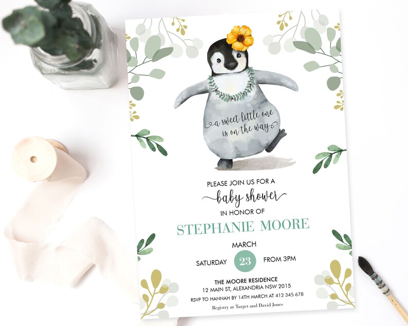May include: A baby shower invitation with a watercolor illustration of a penguin wearing a flower crown and a lei. The invitation is decorated with green and gold floral accents. The text on the invitation reads "a sweet little one is on the way" and "Please join us for a baby shower in honor of Stephanie Moore. Saturday, March 23 from 3pm. The Moore Residence, 12 Main St, Alexandria NSW 2015. RSVP to Hannah by 14th March at 412 345 678. Registry at Target and David Jones."