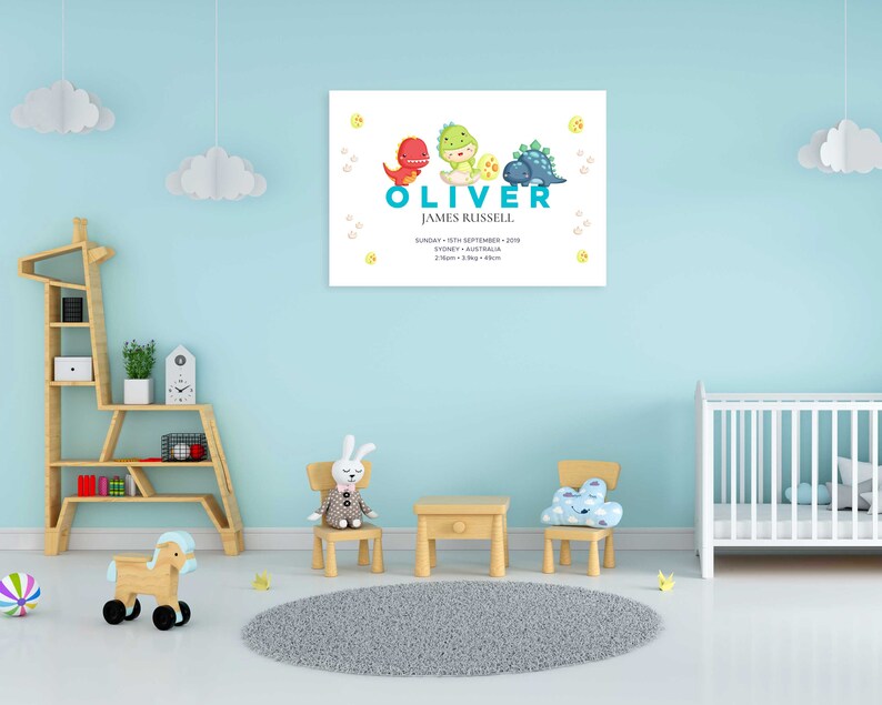May include: A blue and white dinosaur themed baby nursery print with the name Oliver James Russell, the date Sunday 15th September 2019, the location Sydney, Australia, and the time 2:10am, 3.8kg, 48cm.