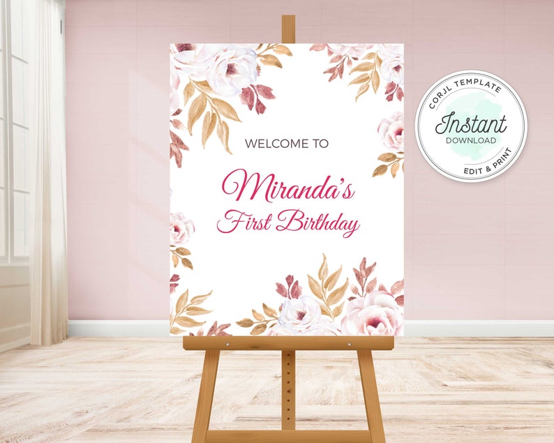 May include: A white welcome sign with a floral border in shades of pink and gold. The text reads "Welcome to Miranda's First Birthday".