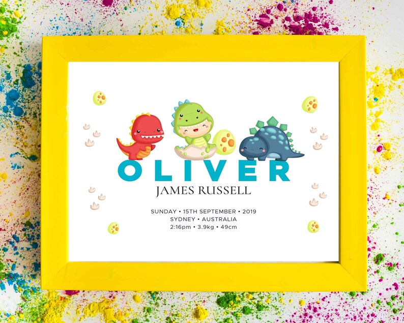 May include: A yellow frame with a white background featuring a dinosaur-themed baby announcement for Oliver James Russell. The announcement includes the date, time, weight, and length of the baby. The dinosaurs are green, blue, and red.