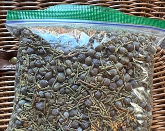 Dry organic juniper berries with a small green leaves