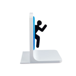 May include: White bookend shaped like a person falling through a blue portal. The person is black and has a stick figure design.