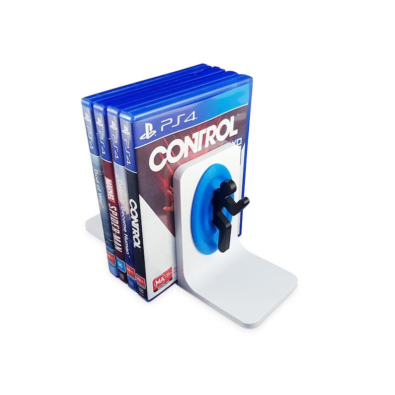 May include: A white plastic bookend with a blue circle and a black figure. The bookend is holding up a stack of five video game cases. The cases are for PlayStation 4 games, including "Control", "Detroit: Become Human", "Marvel's Spider-Man", and "God of War".