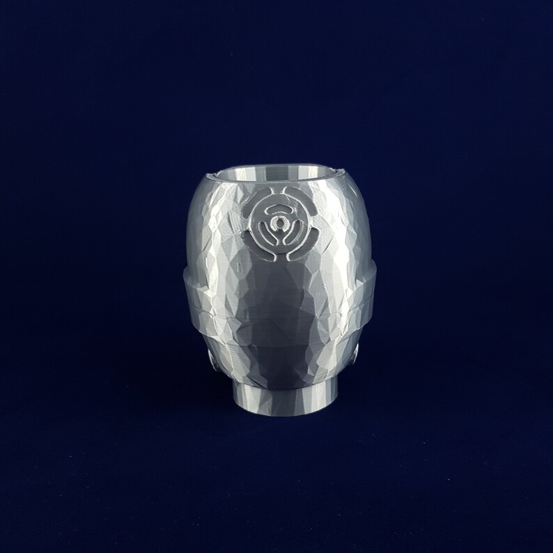 May include: A white ceramic planter with a textured surface and a geometric design. The planter has a round shape and a wide opening.