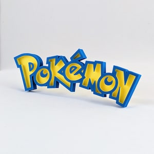 May include: A blue and yellow 3D printed word "Pokemon" with a blue outline and yellow fill.