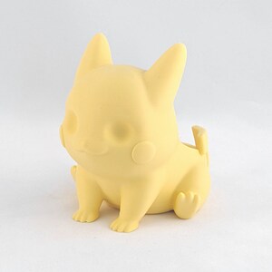 May include: A yellow Pikachu-shaped planter made of plastic. The planter is sitting on a white surface.